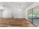 Open living area featuring wood flooring, a vaulted ceiling, sliding doors and open access to the kitchen at 6057 Se 39Th Ave, Ocala, FL 34480