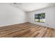 Open living space featuring wood flooring, a large window, and a neutral color palette at 6057 Se 39Th Ave, Ocala, FL 34480