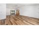 Bright living room showcasing wood flooring, ceiling fan, open layout, and access to the kitchen at 6057 Se 39Th Ave, Ocala, FL 34480