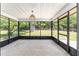 Spacious screened porch with concrete flooring, open views of backyard, and overhead lighting at 6057 Se 39Th Ave, Ocala, FL 34480