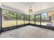 Large screened porch with open backyard view, concrete flooring, and overhead lighting at 6057 Se 39Th Ave, Ocala, FL 34480