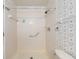 Shower stall with tiled walls and safety bar showcasing accessibility and practicality at 6057 Se 39Th Ave, Ocala, FL 34480