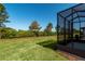 Beautiful backyard with a screened-in lanai overlooking the green lawn at 6132 Sw 94Th Ter, Ocala, FL 34481