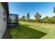 Expansive backyard featuring well-maintained green grass and a screened-in lanai at 6132 Sw 94Th Ter, Ocala, FL 34481