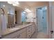 Spacious bathroom featuring dual sinks, granite countertops, and an open walk-in closet at 6132 Sw 94Th Ter, Ocala, FL 34481