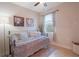 Bright bedroom with tiled floors, window and artwork at 6132 Sw 94Th Ter, Ocala, FL 34481