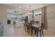 Bright dining area flows into modern kitchen with granite counters, white cabinetry and stainless steel appliances at 6132 Sw 94Th Ter, Ocala, FL 34481