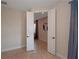 Hallway with open double doors leading to a room with a mirror and comfortable chair at 6132 Sw 94Th Ter, Ocala, FL 34481