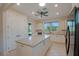Bright kitchen with white cabinets, granite countertops, tile flooring, black appliances, and a center island at 6132 Sw 94Th Ter, Ocala, FL 34481