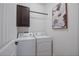 Laundry room featuring washer, dryer, cabinet and artwork at 6132 Sw 94Th Ter, Ocala, FL 34481