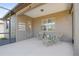 Inviting screened patio features neutral tones, comfortable seating and a relaxing atmosphere at 6132 Sw 94Th Ter, Ocala, FL 34481
