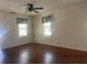Bright bedroom with hardwood floors and two large, sunlit windows at 621 Ne 20Th St, Ocala, FL 34470