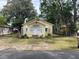Charming yellow home with white trim, a classic bungalow-style facade, and a cozy garden area at 621 Ne 20Th St, Ocala, FL 34470