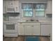 Modern kitchen with white appliances, cabinets and countertops, plus a stainless steel sink and microwave at 621 Ne 20Th St, Ocala, FL 34470