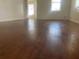 Spacious living room with wood floors, neutral walls, and ample natural light at 621 Ne 20Th St, Ocala, FL 34470