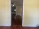 Bright living room with hardwood floors and open view to kitchen at 621 Ne 20Th St, Ocala, FL 34470
