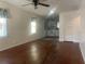 Spacious living room featuring hardwood floors with a view into the eat-in kitchen at 621 Ne 20Th St, Ocala, FL 34470