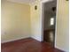 Cozy living room with hardwood floors, neutral paint, and an open doorway at 621 Ne 20Th St, Ocala, FL 34470