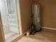 Interior room with an older hot water heater and painted concrete block walls and tile flooring at 621 Ne 20Th St, Ocala, FL 34470