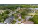 Aerial view of a home nestled in a community with lush greenery and mature trees at 6882 Sw 113Th Pl, Ocala, FL 34476