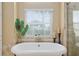 A close-up of the bathtub showing the nice window at 6882 Sw 113Th Pl, Ocala, FL 34476