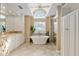 Luxurious bathroom features a soaking tub, walk-in shower, and dual vanities with granite countertops at 6882 Sw 113Th Pl, Ocala, FL 34476