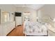 Bright bedroom boasts wood floors, a large window, and access to the en-suite bathroom at 6882 Sw 113Th Pl, Ocala, FL 34476