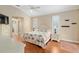 Bright bedroom with hardwood floors, neutral walls, and sunny windows at 6882 Sw 113Th Pl, Ocala, FL 34476