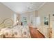 Cozy bedroom with wood floors, crown moulding, and sliding doors leading to the pool at 6882 Sw 113Th Pl, Ocala, FL 34476