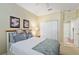 Comfortable bedroom with neutral tones, ceiling fan, closet, and ensuite bathroom access at 6882 Sw 113Th Pl, Ocala, FL 34476