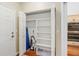 A storage closet featuring multiple shelves and a cleaning rack at 6882 Sw 113Th Pl, Ocala, FL 34476