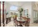 Bright dining room with high ceilings, large windows, chandelier, and a view into the garden at 6882 Sw 113Th Pl, Ocala, FL 34476