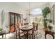 Dining area with a large window, wood table, and cabinetry providing ample storage space at 6882 Sw 113Th Pl, Ocala, FL 34476
