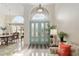 Grand foyer with chandelier, double doors with decorative glass, and views to the formal dining room at 6882 Sw 113Th Pl, Ocala, FL 34476