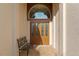 Close-up of the decorative double front doors with leaded glass, set amongst brick pavers at 6882 Sw 113Th Pl, Ocala, FL 34476