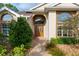 Close up of a home's front entry, showcasing arched windows and a double door entry at 6882 Sw 113Th Pl, Ocala, FL 34476