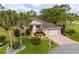 Aerial view of a charming home with mature trees and landscaping, showcasing curb appeal at 6882 Sw 113Th Pl, Ocala, FL 34476