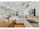 Kitchen featuring white cabinets, granite countertops, stainless appliances, and island with seating at 6882 Sw 113Th Pl, Ocala, FL 34476