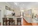 Bright eat-in kitchen features white cabinetry, granite countertops, and hardwood flooring at 6882 Sw 113Th Pl, Ocala, FL 34476