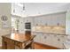 Bright kitchen with white cabinets, granite countertops, stainless appliances, and a kitchen island at 6882 Sw 113Th Pl, Ocala, FL 34476