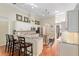 Spacious kitchen with breakfast bar, wood floors, granite countertops, and modern appliances at 6882 Sw 113Th Pl, Ocala, FL 34476