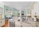 Well-lit kitchen with granite countertops, a breakfast bar, and stainless steel appliances, perfect for cooking at 6882 Sw 113Th Pl, Ocala, FL 34476