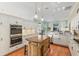 Modern kitchen with stainless steel appliances, an island, granite countertops, and eat-in breakfast area at 6882 Sw 113Th Pl, Ocala, FL 34476