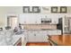 Kitchen featuring white cabinets, granite countertops, stainless appliances, and island with seating at 6882 Sw 113Th Pl, Ocala, FL 34476