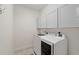 Well-lit laundry room with modern washer and dryer and plenty of storage at 6882 Sw 113Th Pl, Ocala, FL 34476