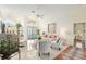 Bright living room featuring vaulted ceilings, elegant decor and natural light from large front windows at 6882 Sw 113Th Pl, Ocala, FL 34476
