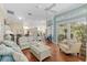 Bright living room featuring hardwood floors, a comfortable seating area, and natural light from sliding doors at 6882 Sw 113Th Pl, Ocala, FL 34476