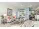 Bright living room features tile flooring, floral patterned sofas, fireplace, and view of the pool at 6882 Sw 113Th Pl, Ocala, FL 34476