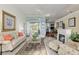 Bright living room features marble floors, neutral furnishings, and an indoor fireplace at 6882 Sw 113Th Pl, Ocala, FL 34476