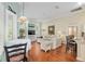 Inviting living room adjacent to the kitchen with hardwood floors, natural light, and comfortable seating at 6882 Sw 113Th Pl, Ocala, FL 34476